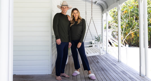 couple wearing Sleepy Merino pyjamas on verandah