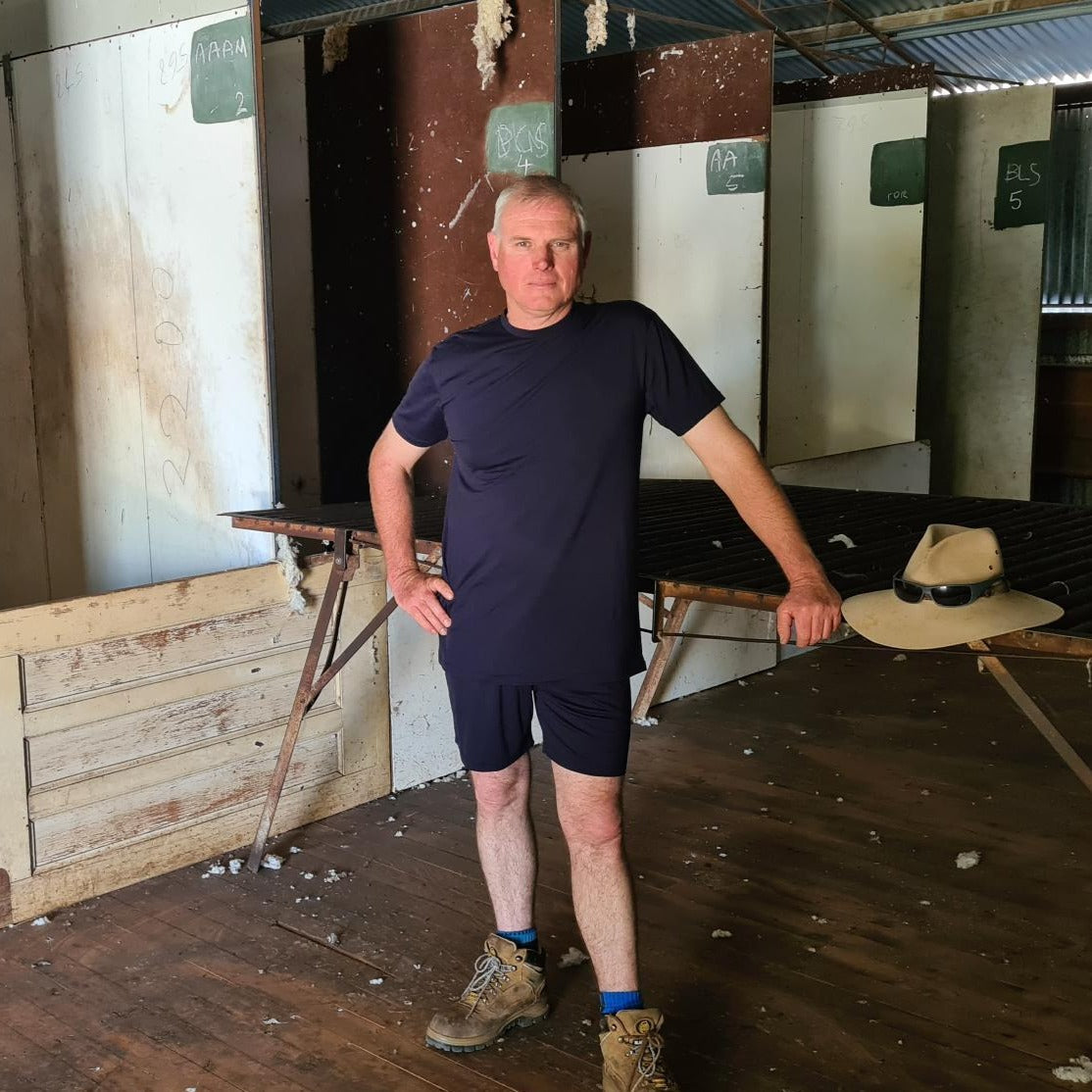 Julie's brother in the shearing shed wearing Merino tee