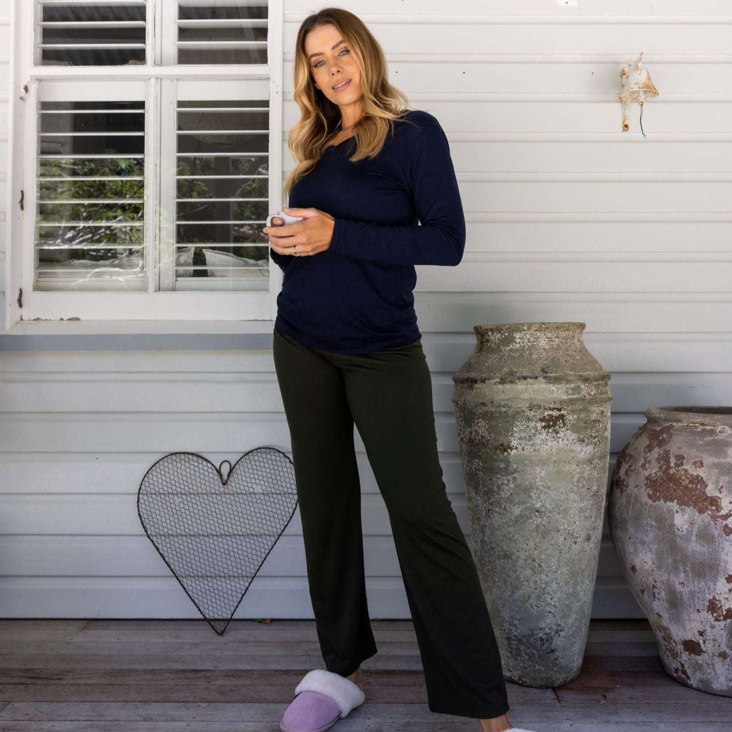 model on verandah wearing plantation green pajama pants