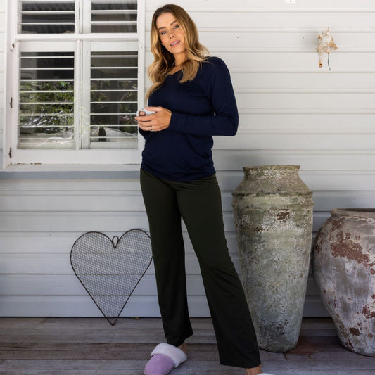 model on verandah wearing plantation green pajama pants